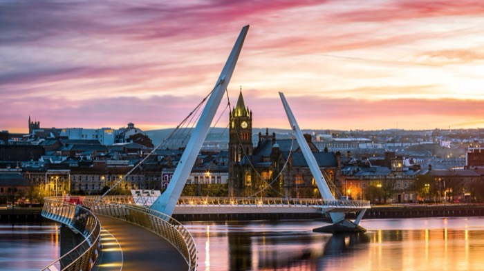 The white curves of the Peace Bridge over the River Foyle at sunset