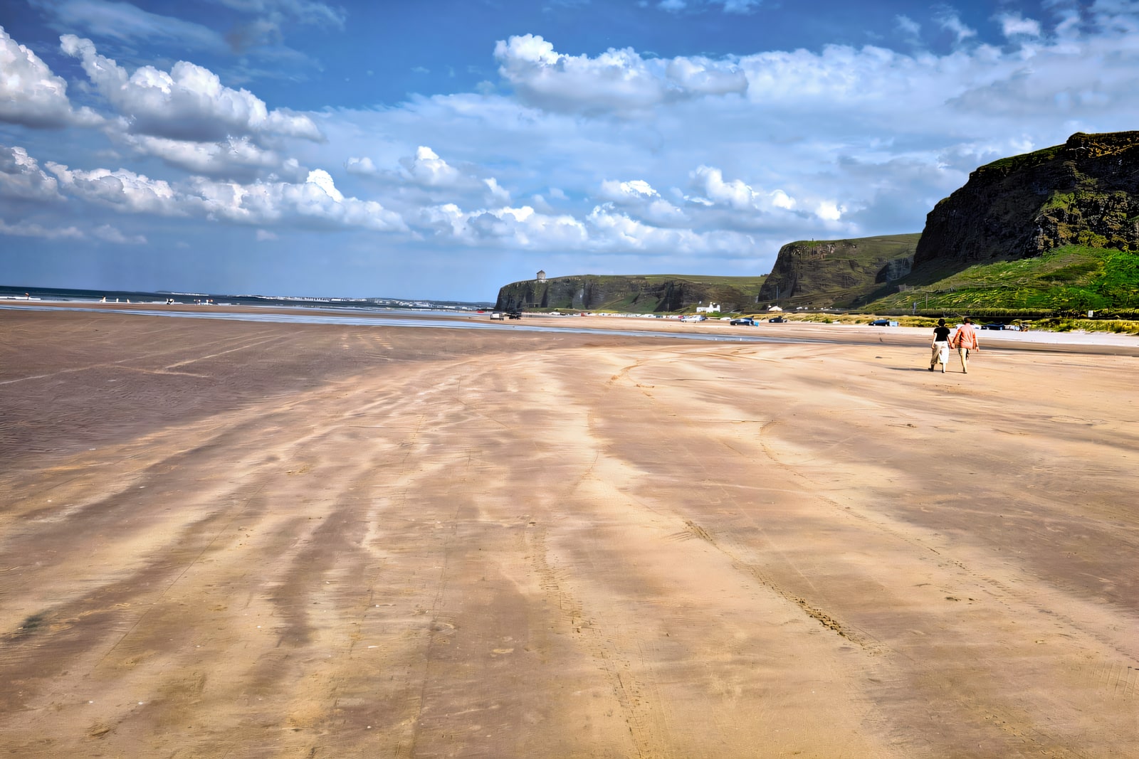 A wide sandy Northern Ireland beach with a boardwalk onto the sand