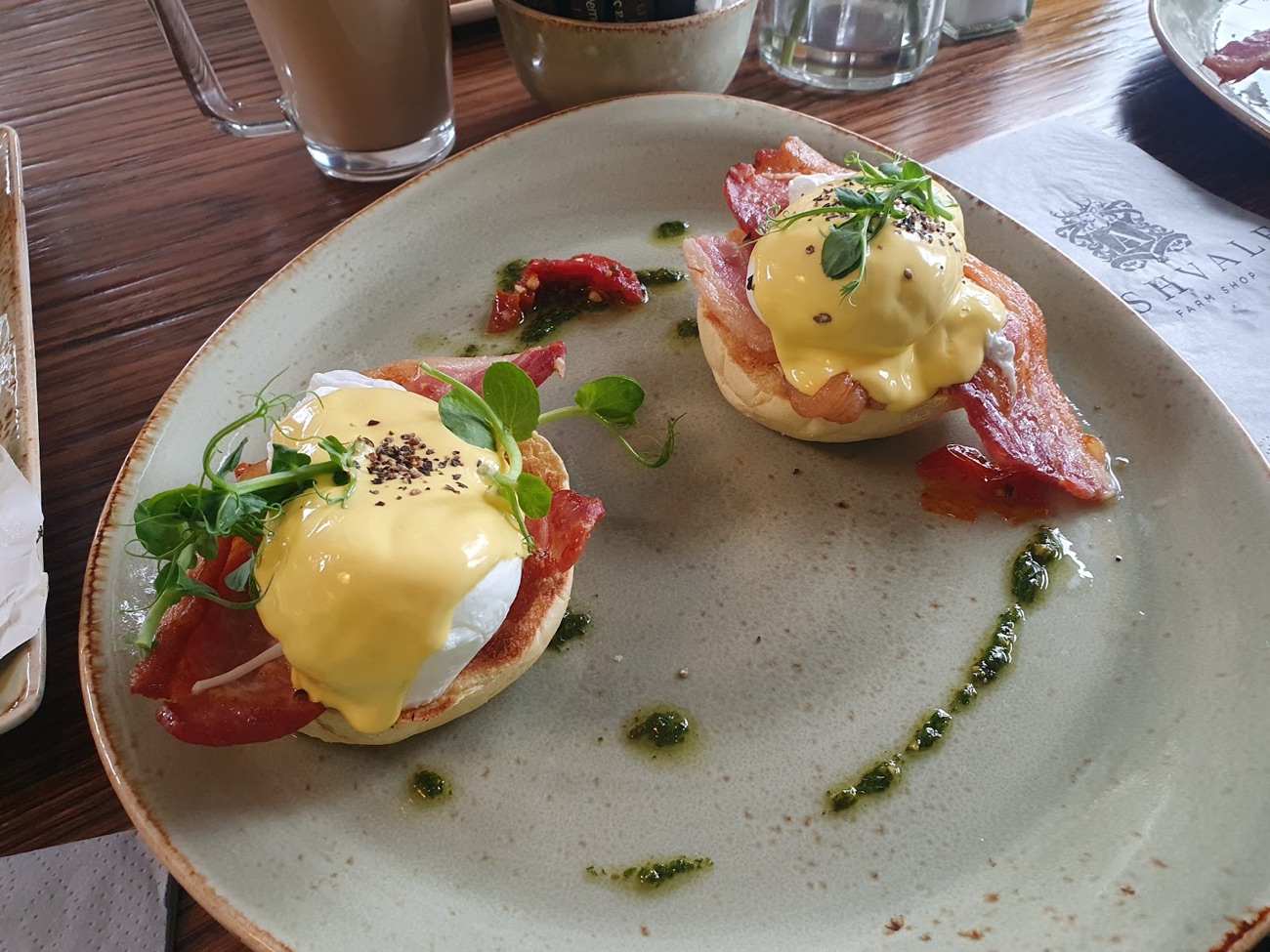 Eggs benedict with bacon and pea shoots on an Ashvale Farm Shop napkin