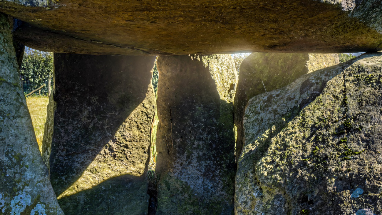 Light slips between the great upright stones of the Neolithic court cairn, one of Northern Ireland's oldest burial monuments.