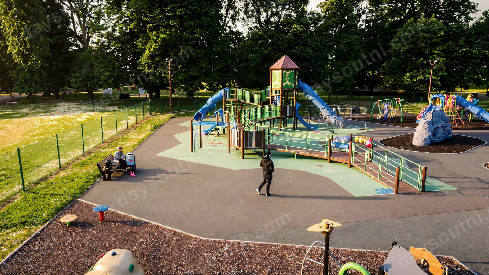 The play park at People's Park, Ballymena — a tall tower with a blue slide and ramped access.