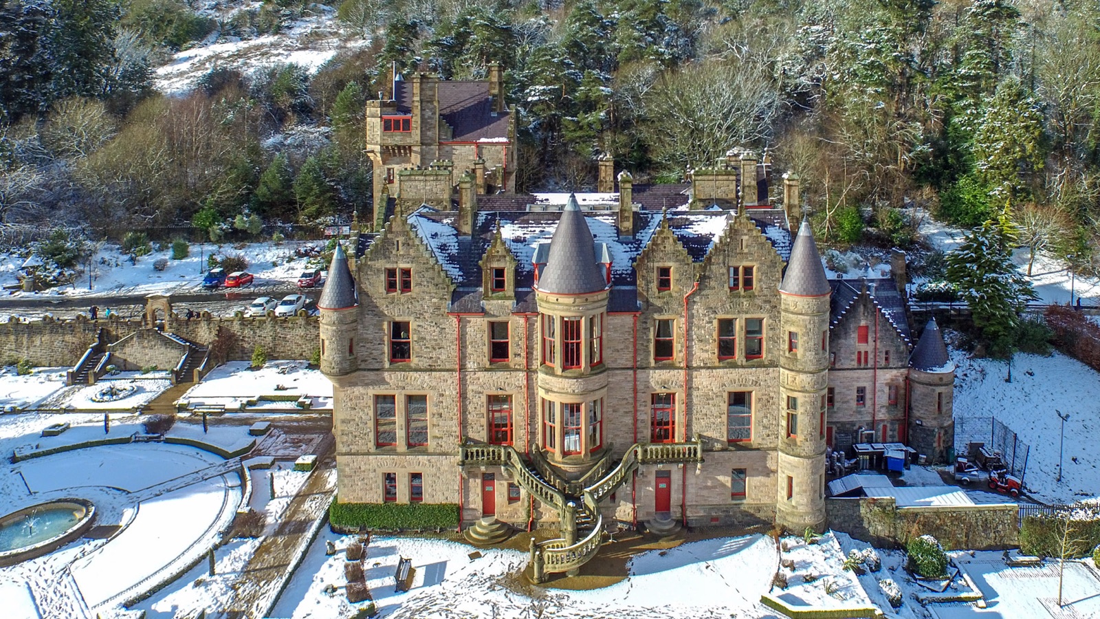 An aerial view of Belfast Castle under a light dusting of snow