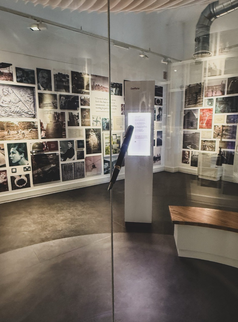 Inside the exhibition at Bellaghy Bawn — a wall of photographs and a touchscreen display telling the story of the place and Seamus Heaney