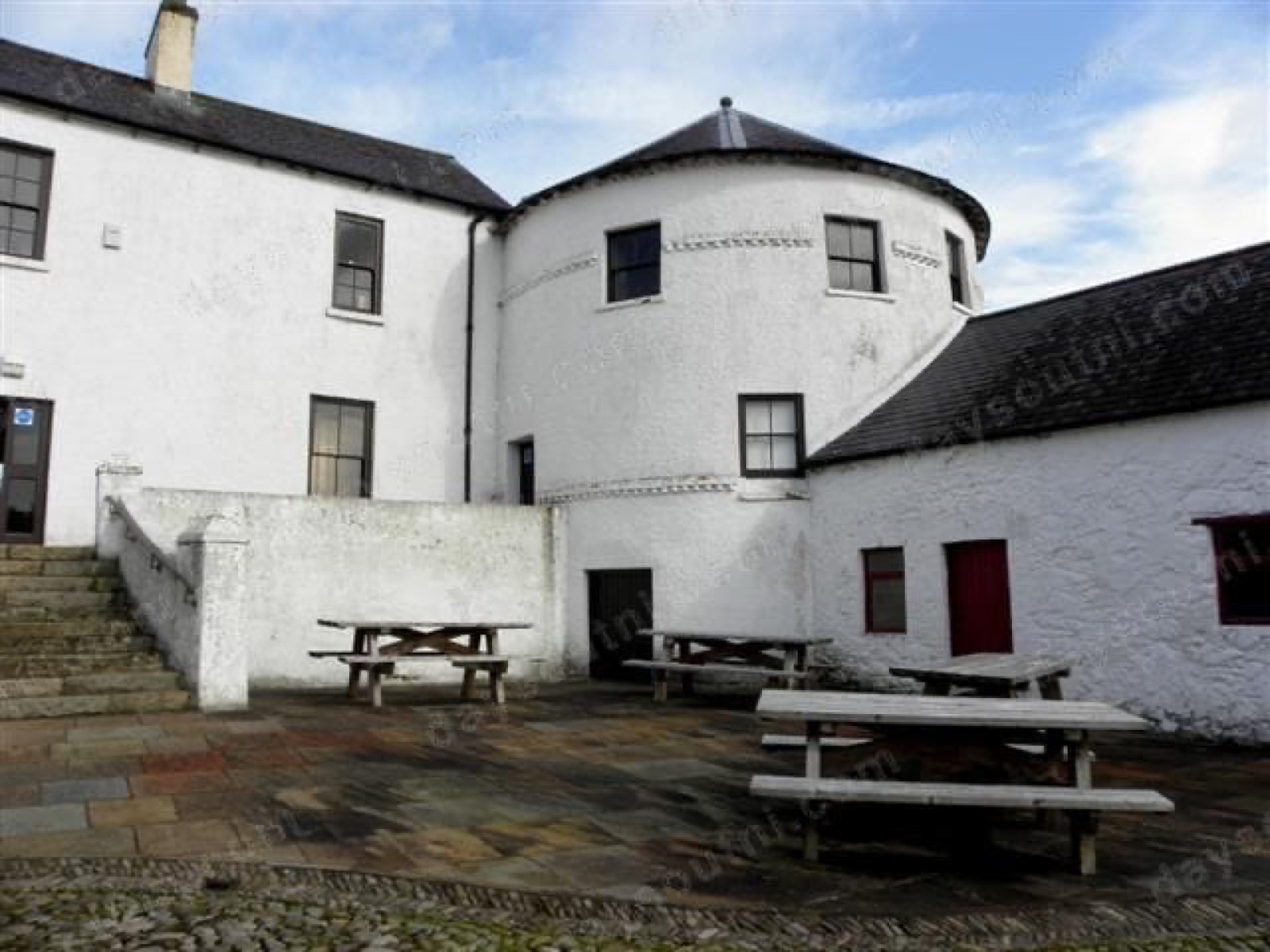 Bellaghy Bawn — the whitewashed round flanker tower with its conical roof rising over the cobbled courtyard