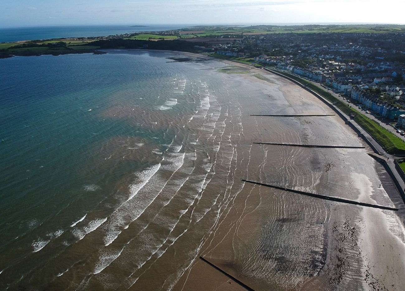 Aerial view of Ballyholme Beach curving past the seafront promenade and houses of Bangor