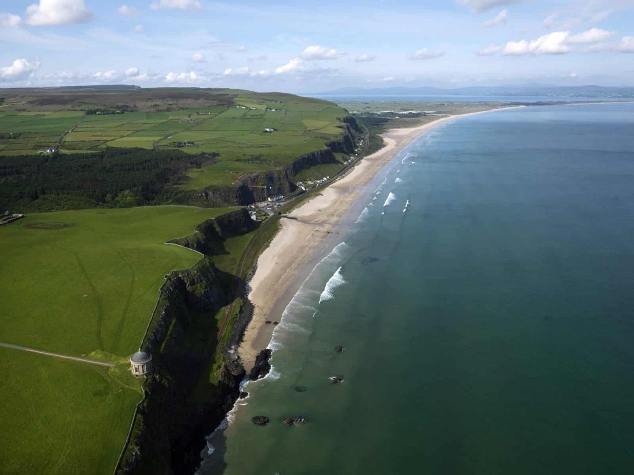 Aerial view of the seven-mile sweep of Benone Strand running below the Binevenagh cliffs