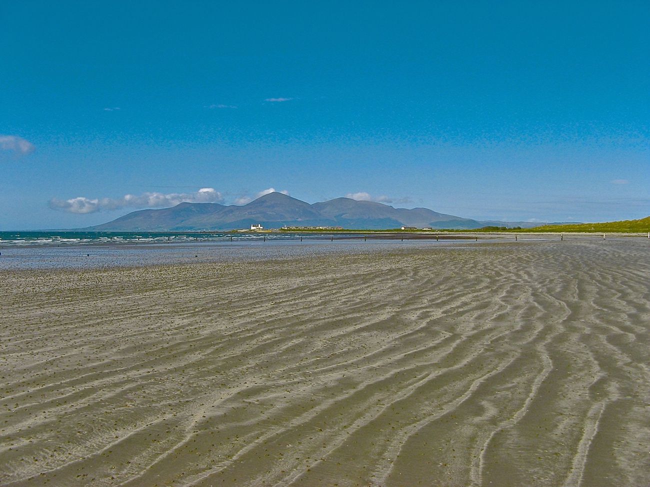 The wide flat sand of Tyrella Beach with the Mourne Mountains across Dundrum Bay