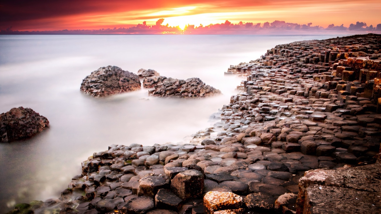 The basalt columns of the Giant's Causeway under a golden sky