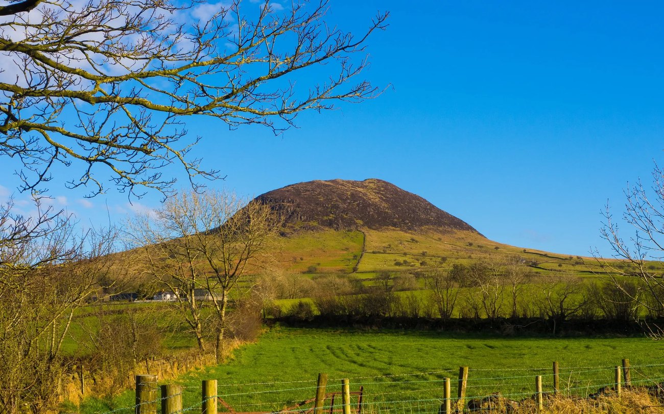 The volcanic hill of Slemish rising from the fields