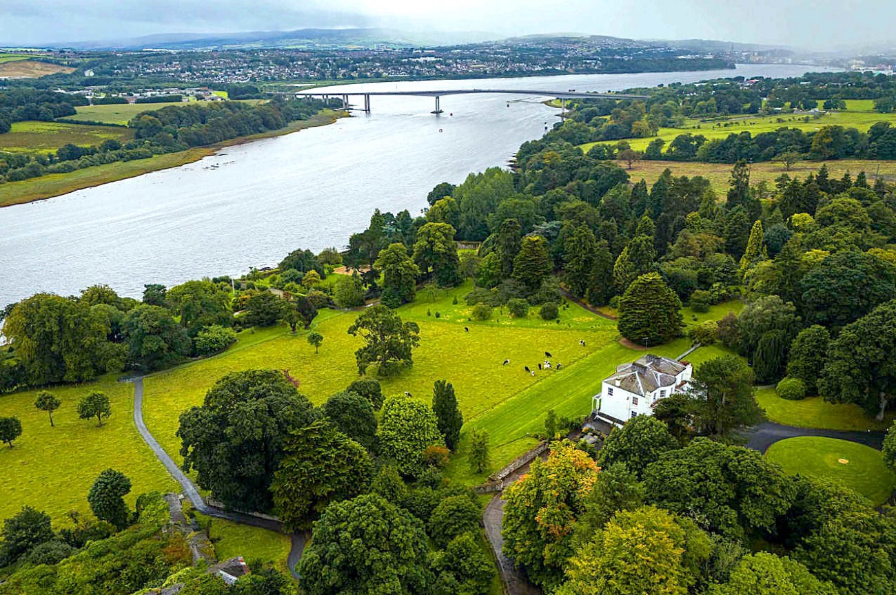 Aerial view of Brook Hall estate on the banks of the River Foyle with the Foyle Bridge beyond