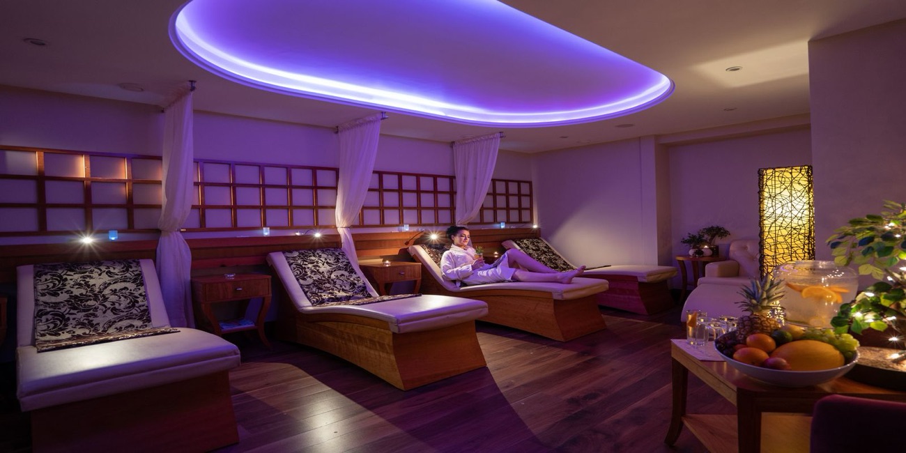Heated loungers under soft mood lighting in the relaxation room.