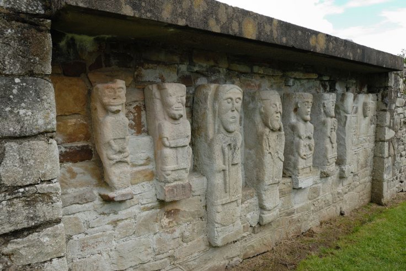 The row of ancient carved stone figures set into the wall of the ruined church on White Island, Lower Lough Erne
