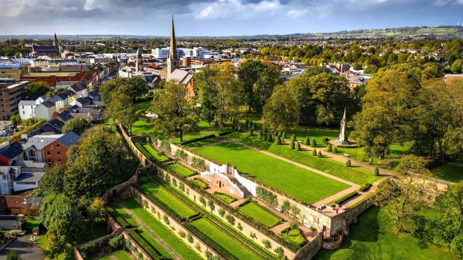 Aerial view of the terraced Castle Gardens in Lisburn with the city and the hills beyond