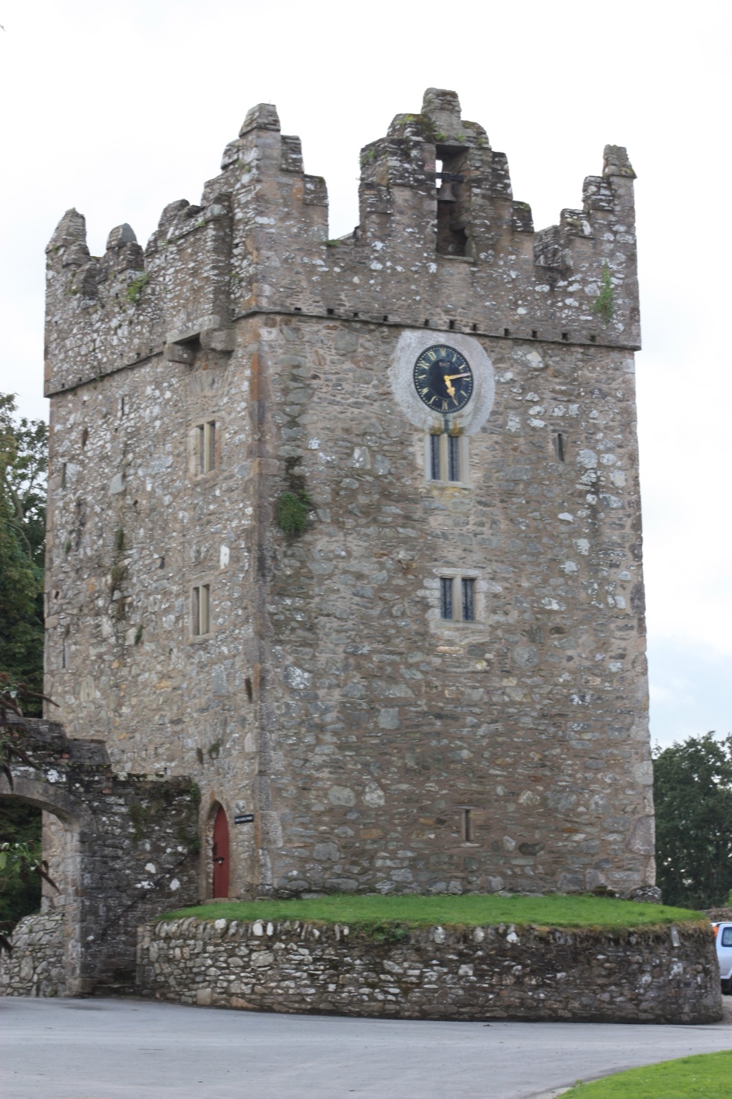 The tall battlemented tower house and clock tower at Castle Ward's farmyard, close up