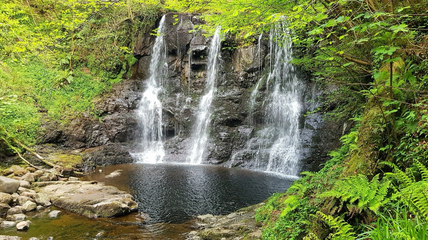 A waterfall on the wooded trail at Glenariff Forest Park