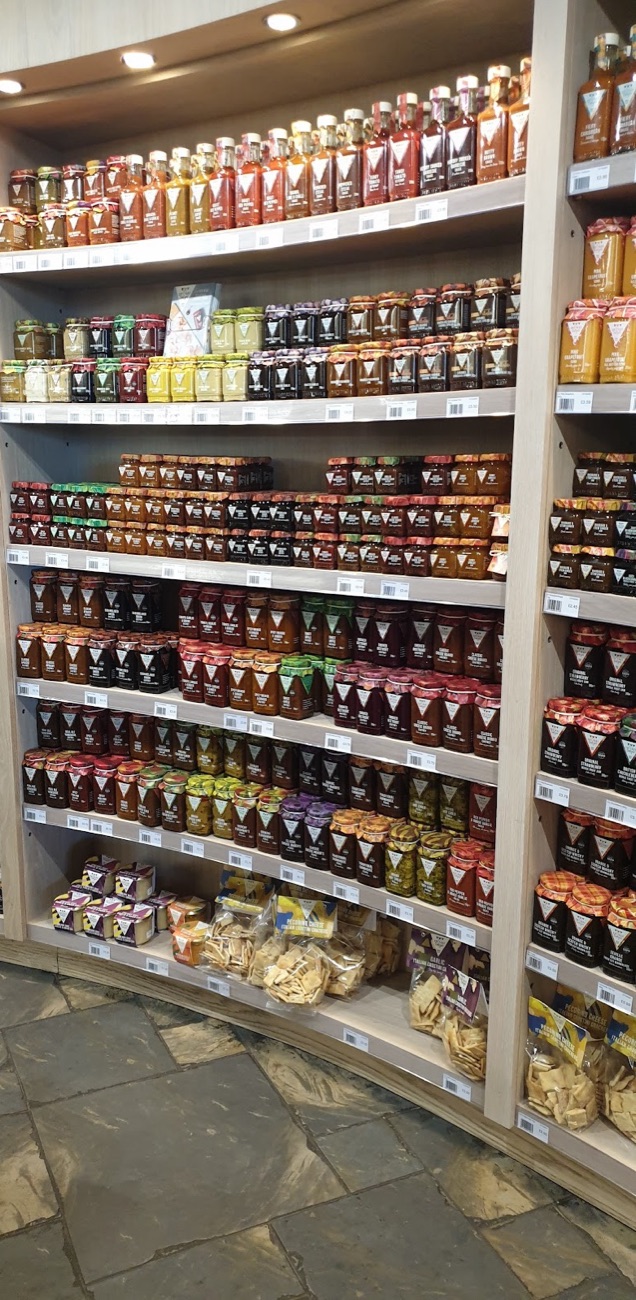 Curved shelves of chutneys, jams and sauces filling the wall at Chapman's
