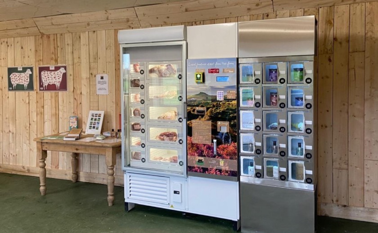 Inside the honesty farm shop — chilled vending lockers of farm-reared meat and shelves of local produce in the timber cabin