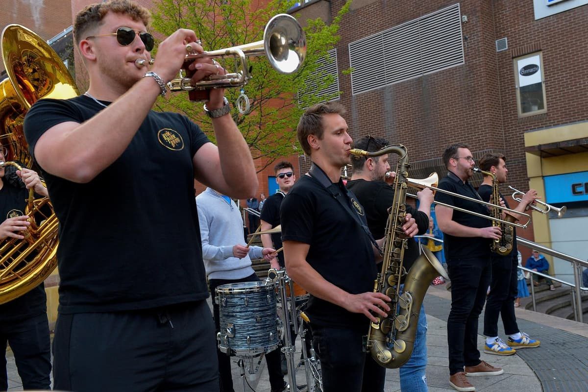 A brass band playing to a crowd on a Derry city-centre street at the jazz festival