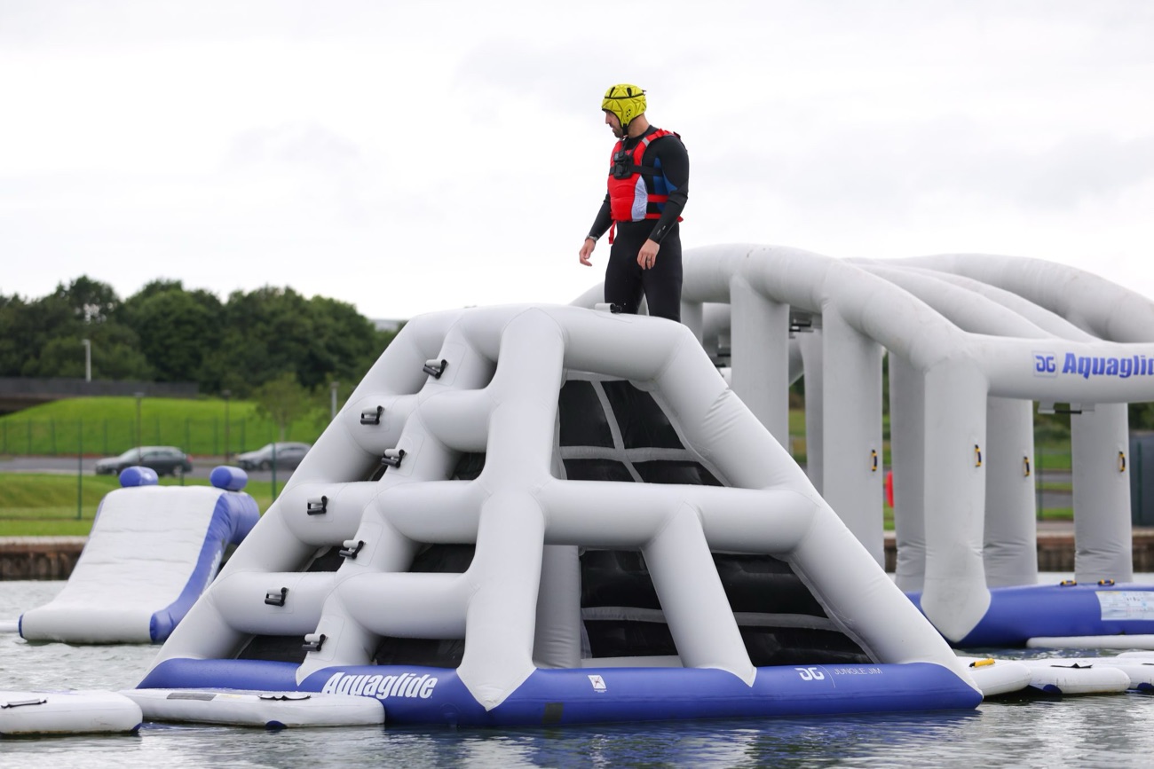 A large inflatable aqua park assault course floating on the lake