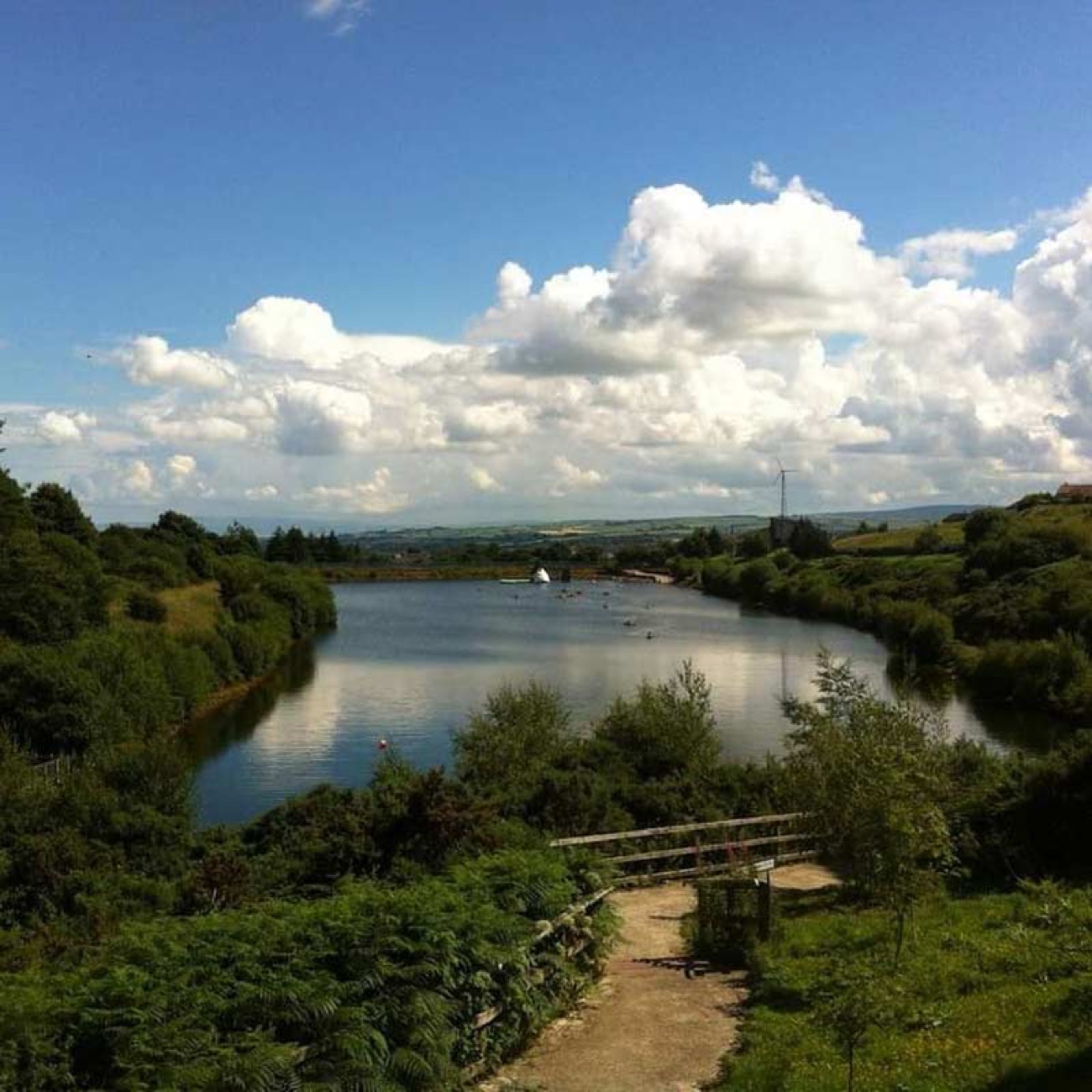 The reservoir at Creggan seen from the bank under a big cloudy sky