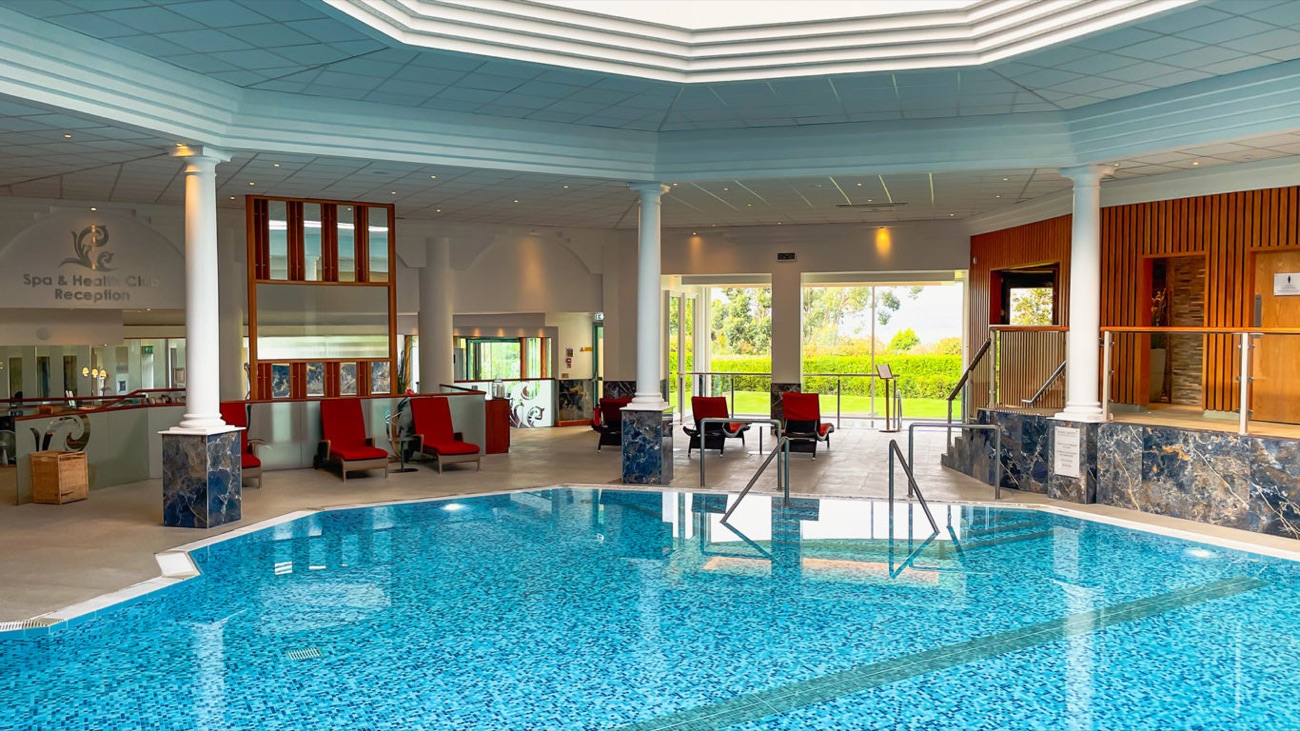 Loungers line the poolside beside the spa and health club reception.
