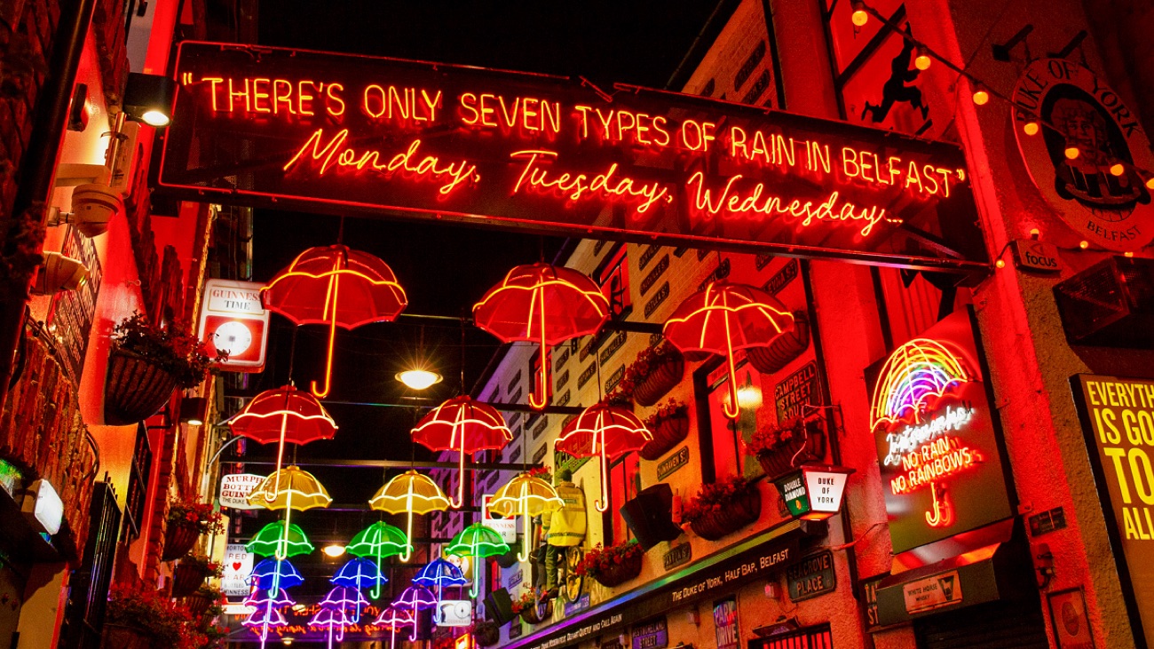 The colourful umbrella and neon-sign alley of Commercial Court in Belfast's Cathedral Quarter