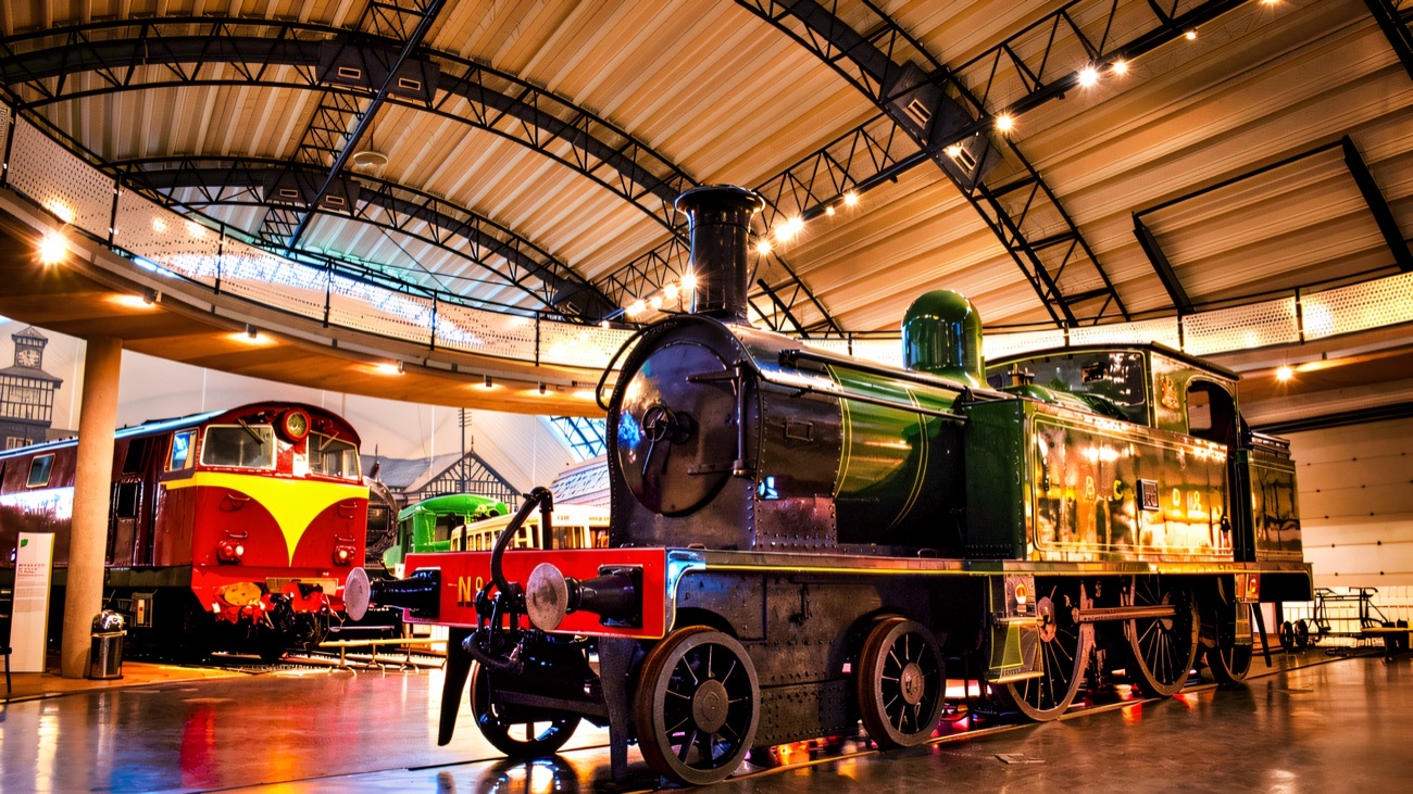 Steam locomotives lined up inside the great railway hall at the Ulster Transport Museum