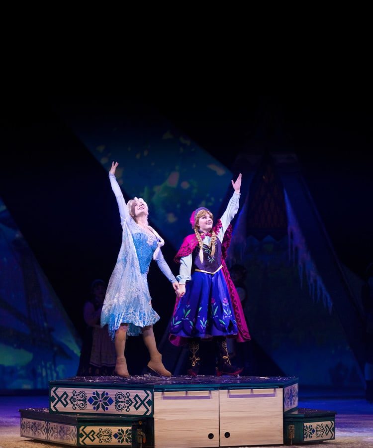 Elsa and Anna from Frozen skating together during a Disney On Ice show