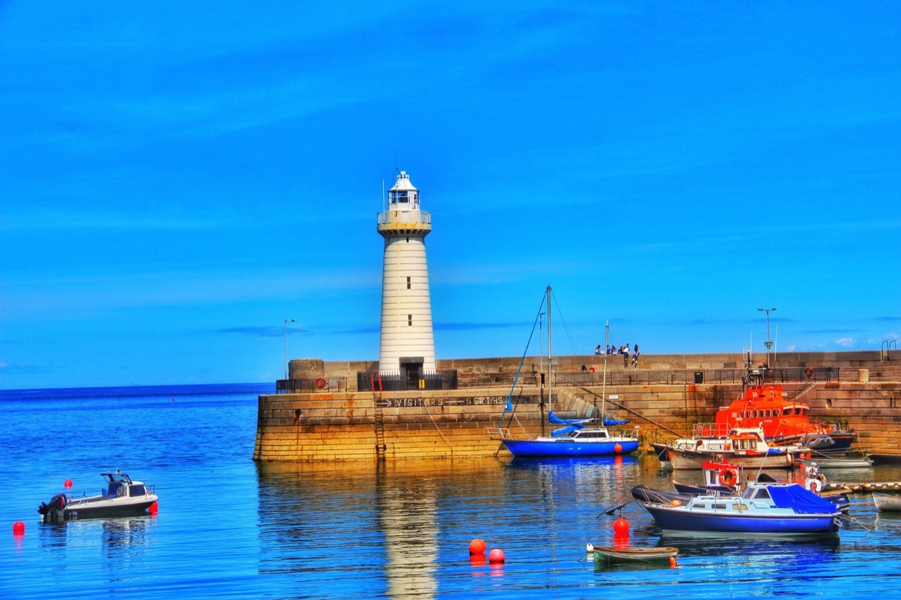 Donaghadee harbour with fishing boats, the lifeboat and the lighthouse on the pier
