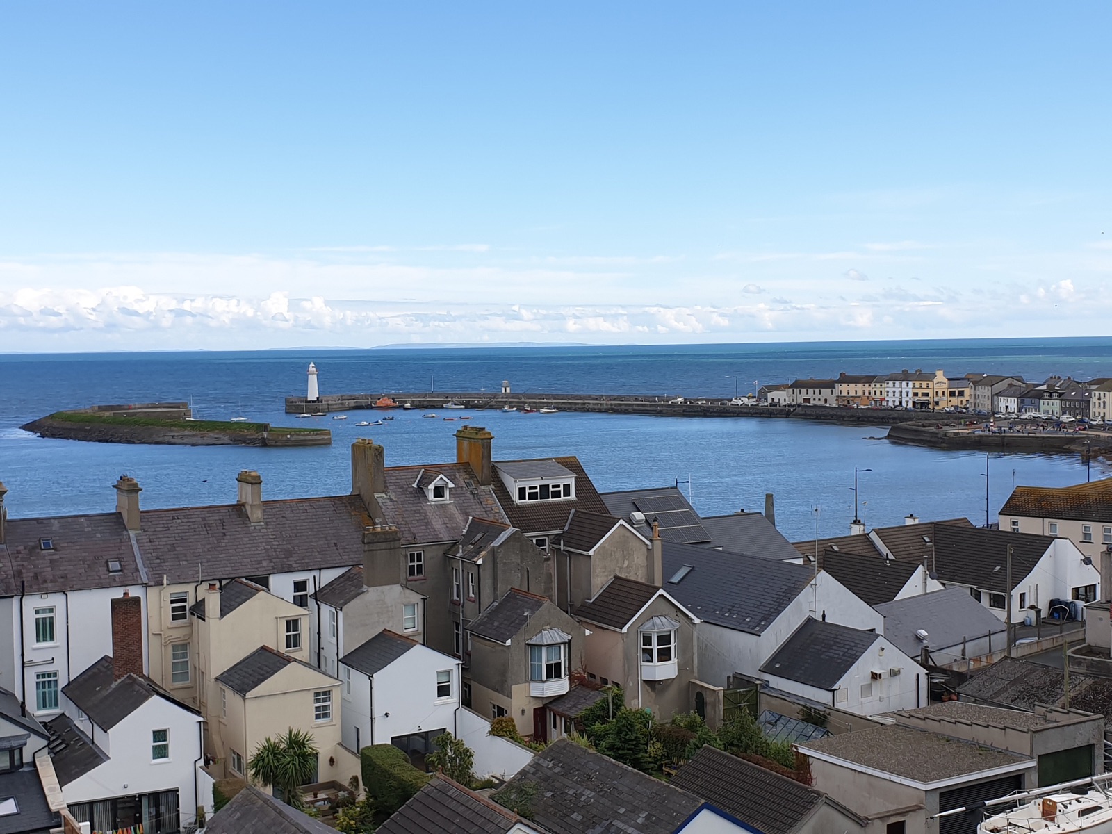 The view from Donaghadee Commons down over the rooftops of the town to the harbour, the lighthouse and the open sea