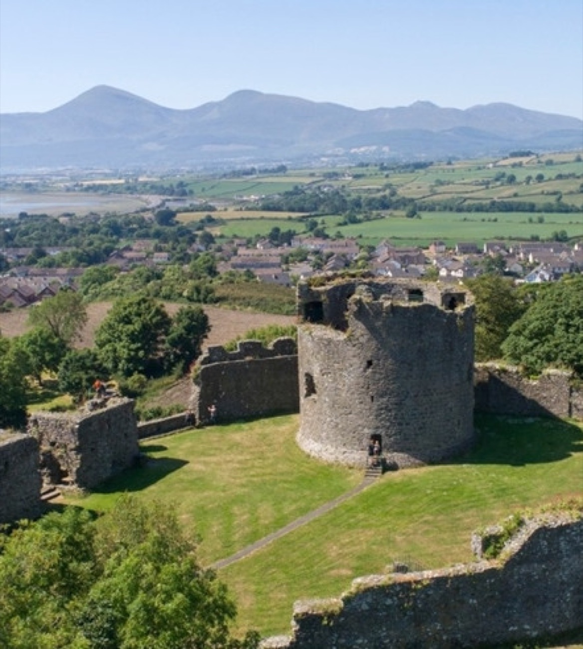 Dundrum Castle keep with the Mourne Mountains and County Down countryside sweeping away behind