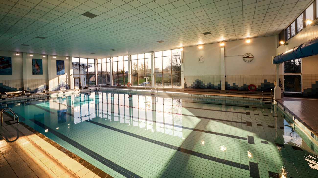 The refurbished swimming pool with glass wall out to the trees