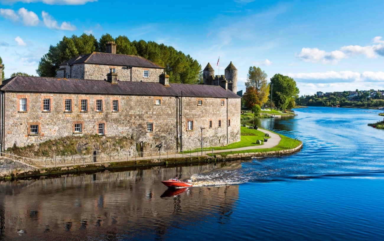 Enniskillen Castle from above, sitting on the River Erne with the wider Fermanagh lakelands stretching away behind