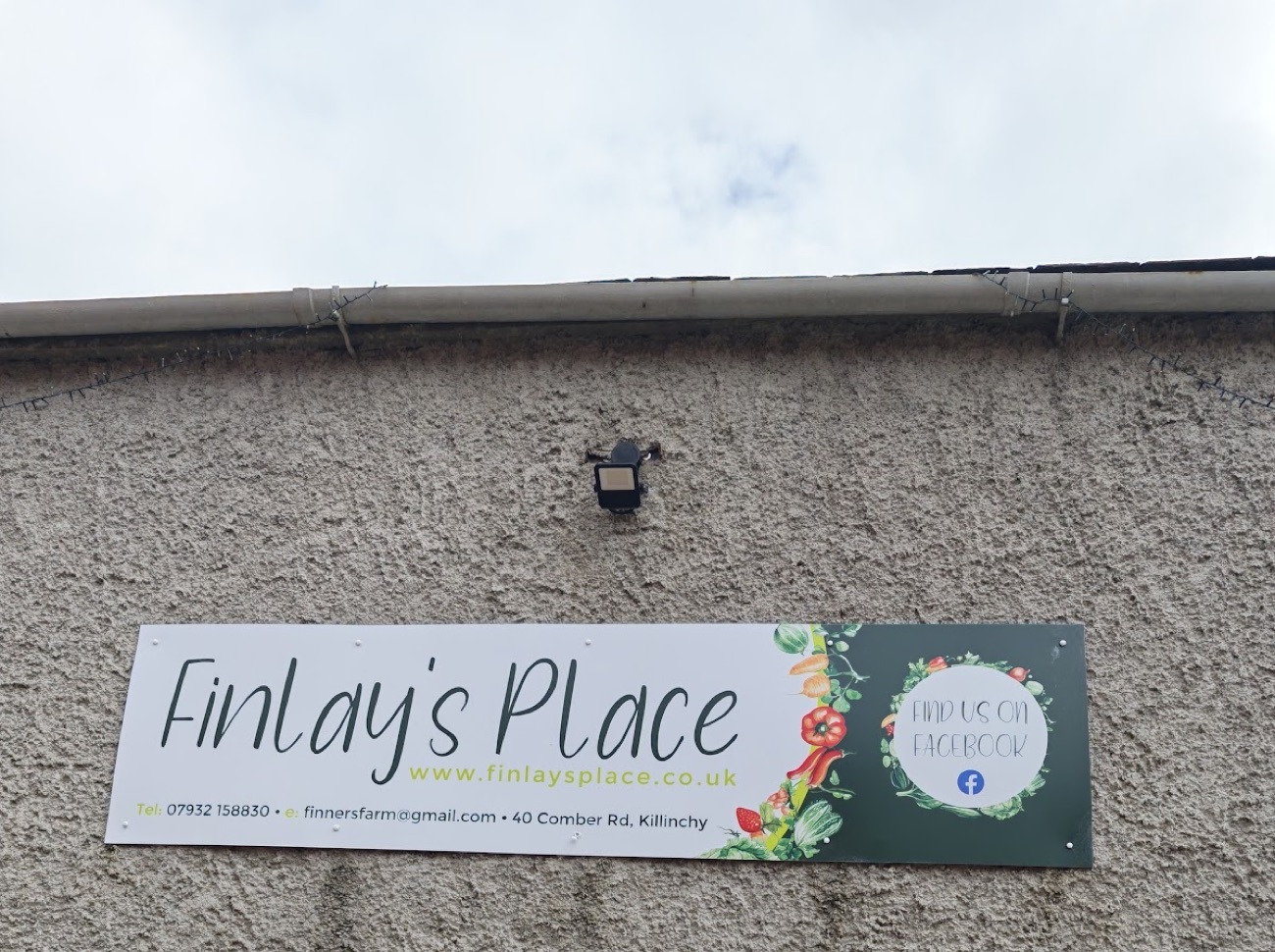 The hand-painted Finlay's Place sign above the door of the stone farm building