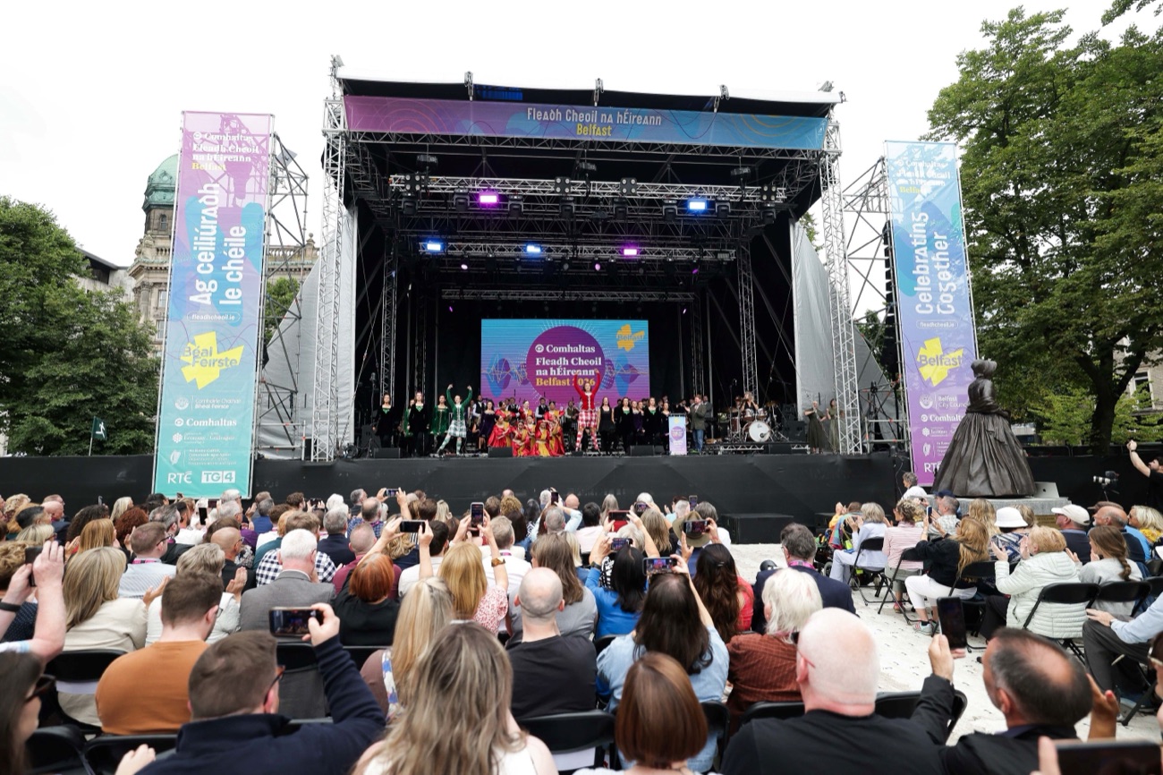 Performers on the Fleadh Cheoil main stage in front of Belfast City Hall with a large seated audience