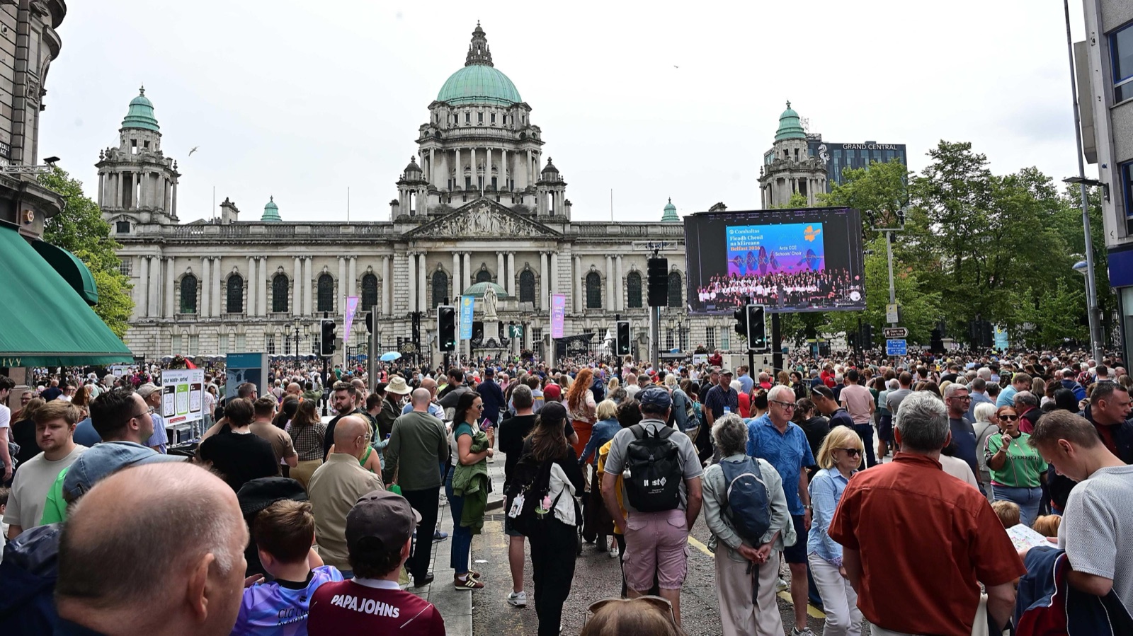 Huge crowds filling the street in front of Belfast City Hall at the Fleadh Cheoil, watching the big screen