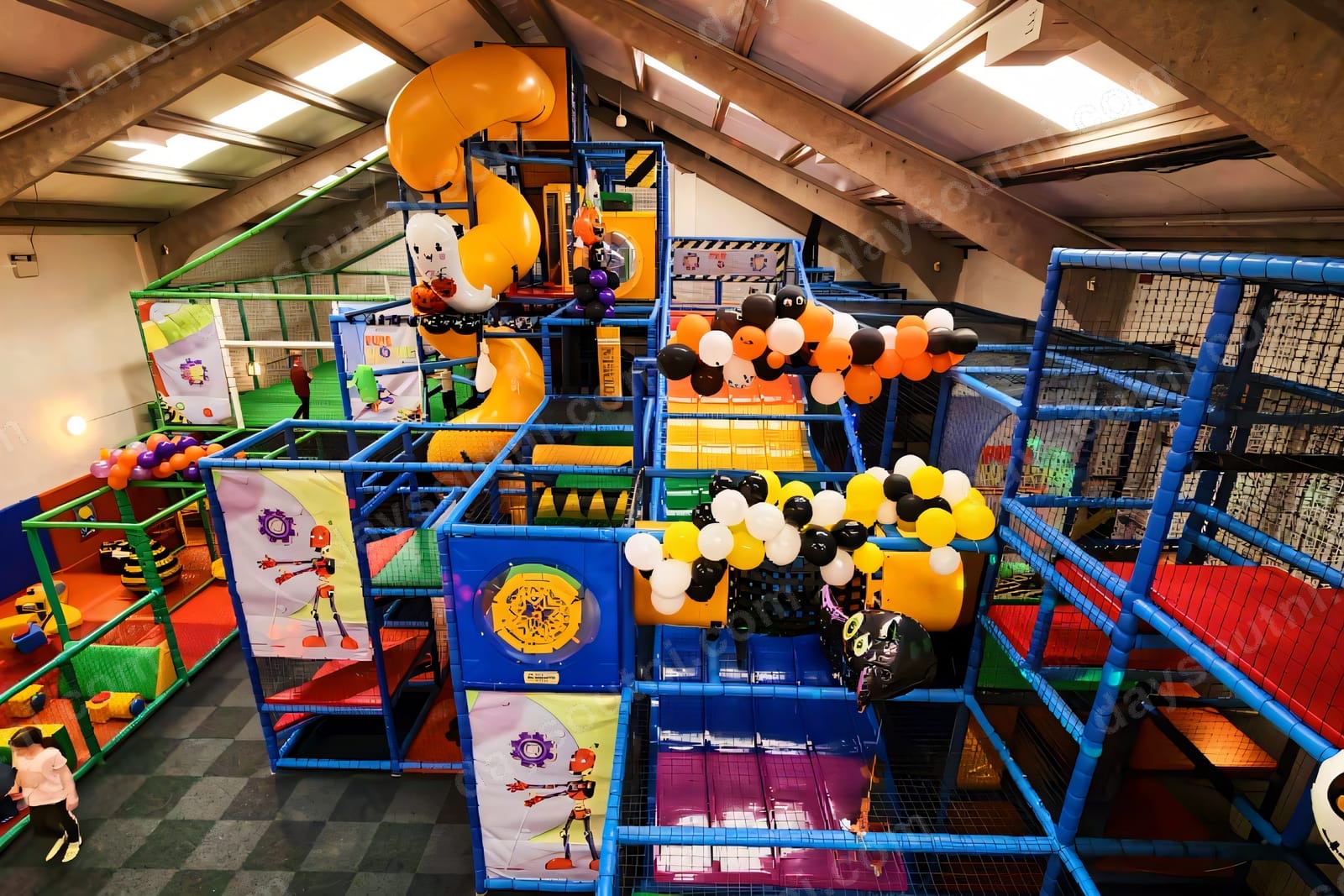 The big multi-level soft play frame at Funworks Glengormley, brightly coloured with slides, balloons and a toddler area
