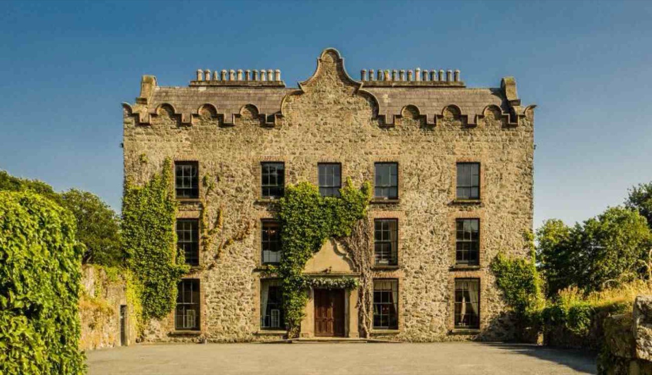 The 17th-century Galgorm Castle in the sun, its Jacobean front draped in ivy