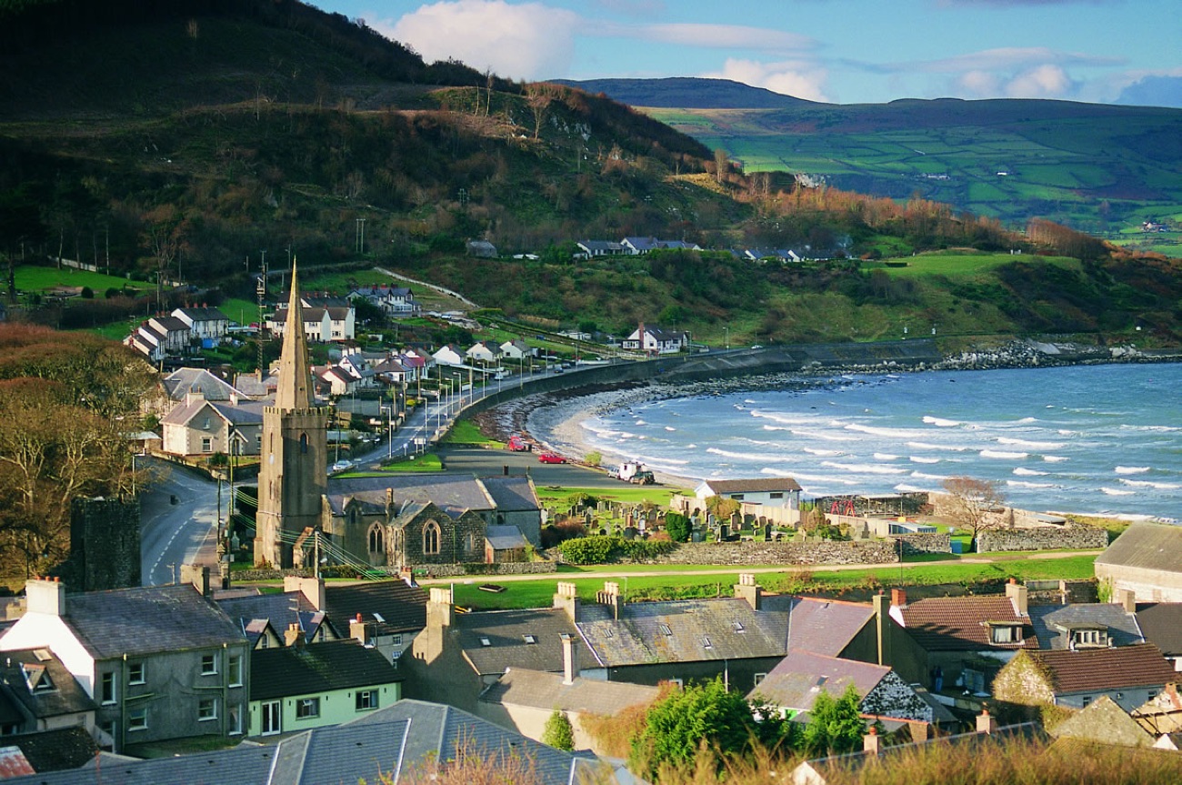 Glenarm village and its bay on the Antrim Coast, with the glens rising behind