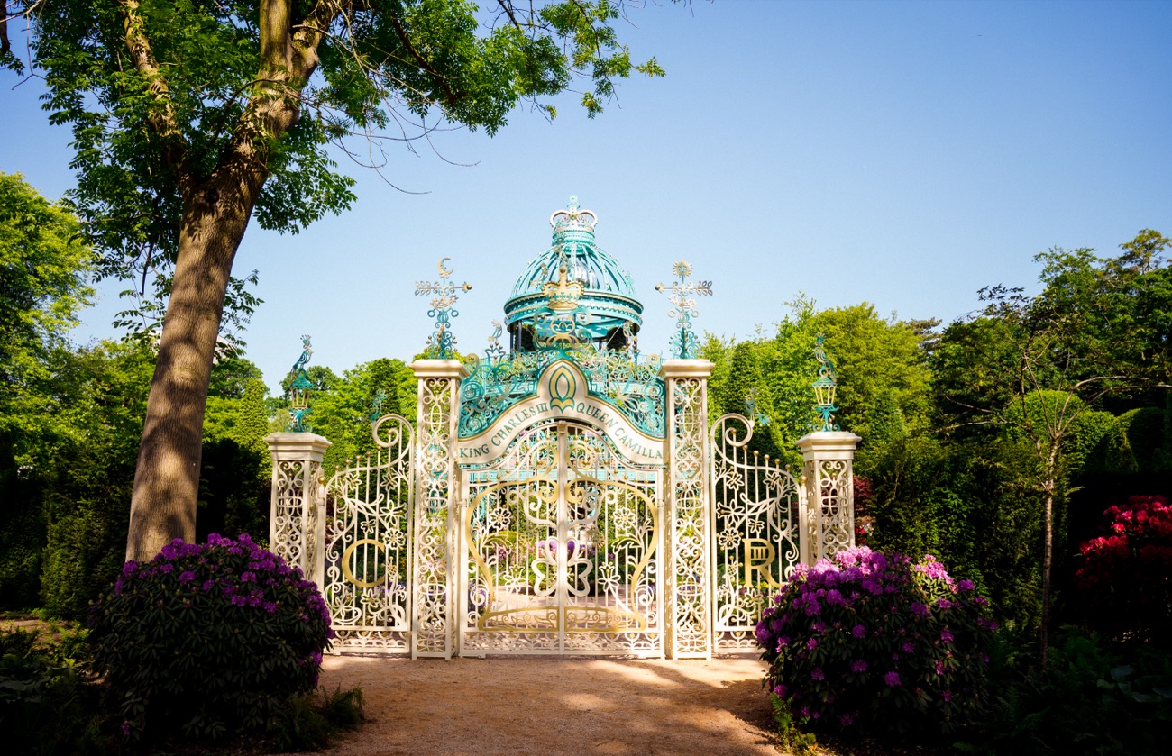 Ornate white and gold entrance gates leading into the Coronation Garden at Hazelbank Park