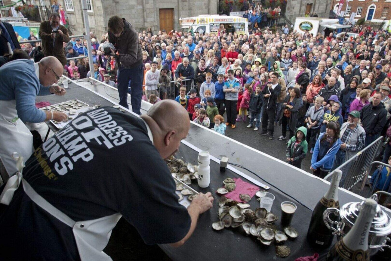 The World Oyster Eating Championship on stage in the village square with a big crowd watching at Hillsborough