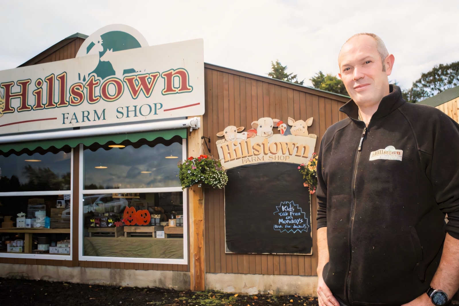The Hillstown butchery counter under a hand-chalked blackboard sign reading Hillstown Farm Shop
