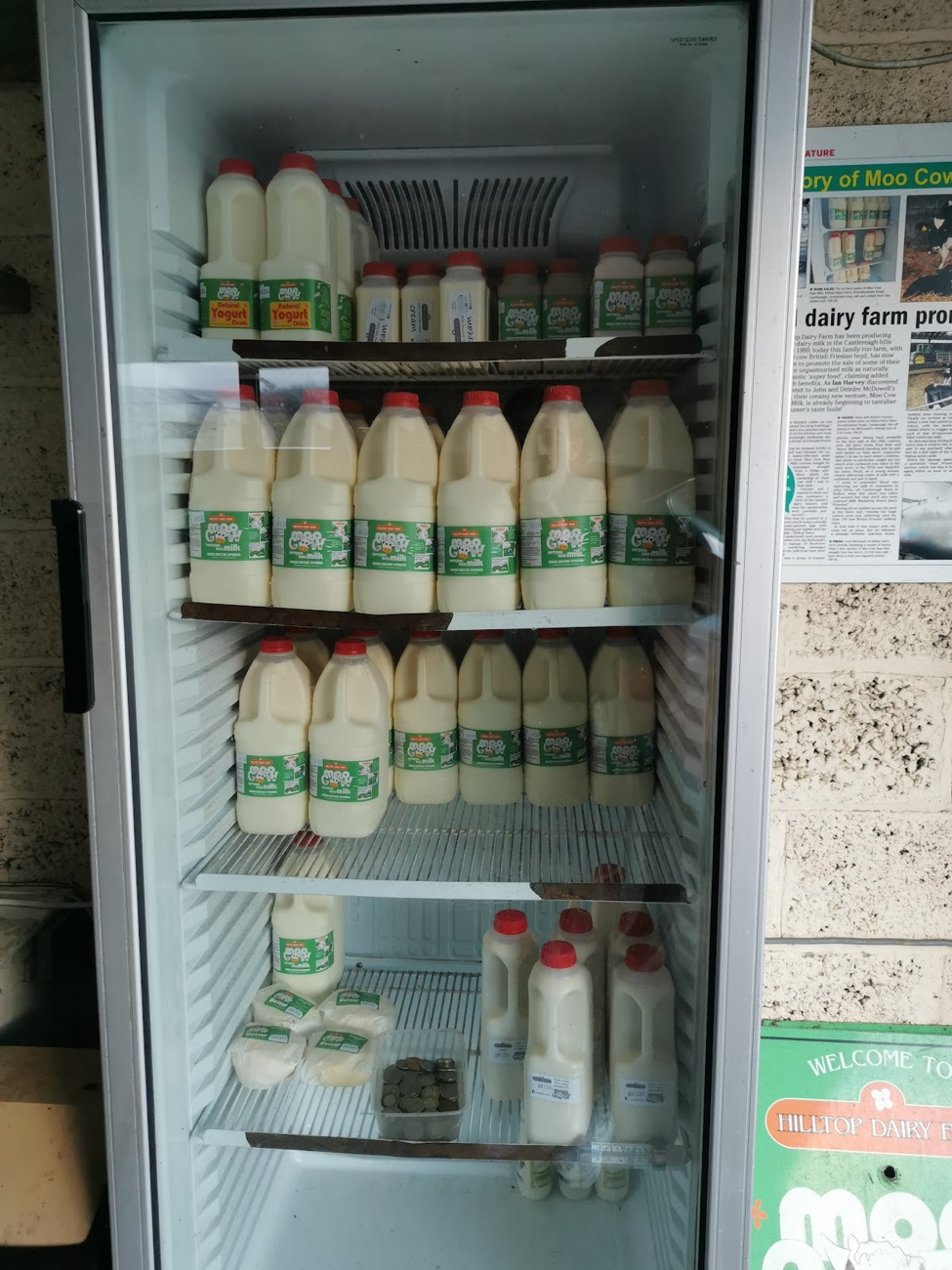 A fridge stocked with Moo Cow milk and milkshake bottles at Hilltop Dairy Farm