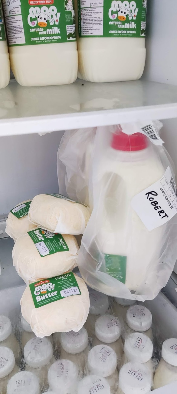 Moo Cow butter and bottled milk on the shelf of the farm fridge
