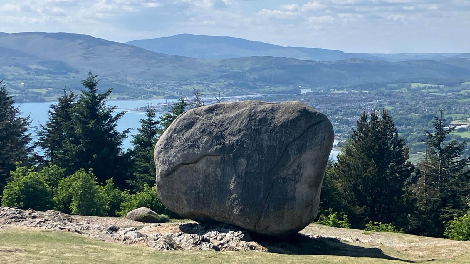 The Cloughmore Stone, a giant granite boulder on the hillside above Rostrevor, with Carlingford Lough and the wooded slopes behind