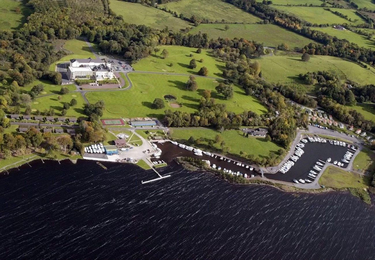 An aerial view of the marina on Lower Lough Erne with rows of moored boats and the manor grounds behind