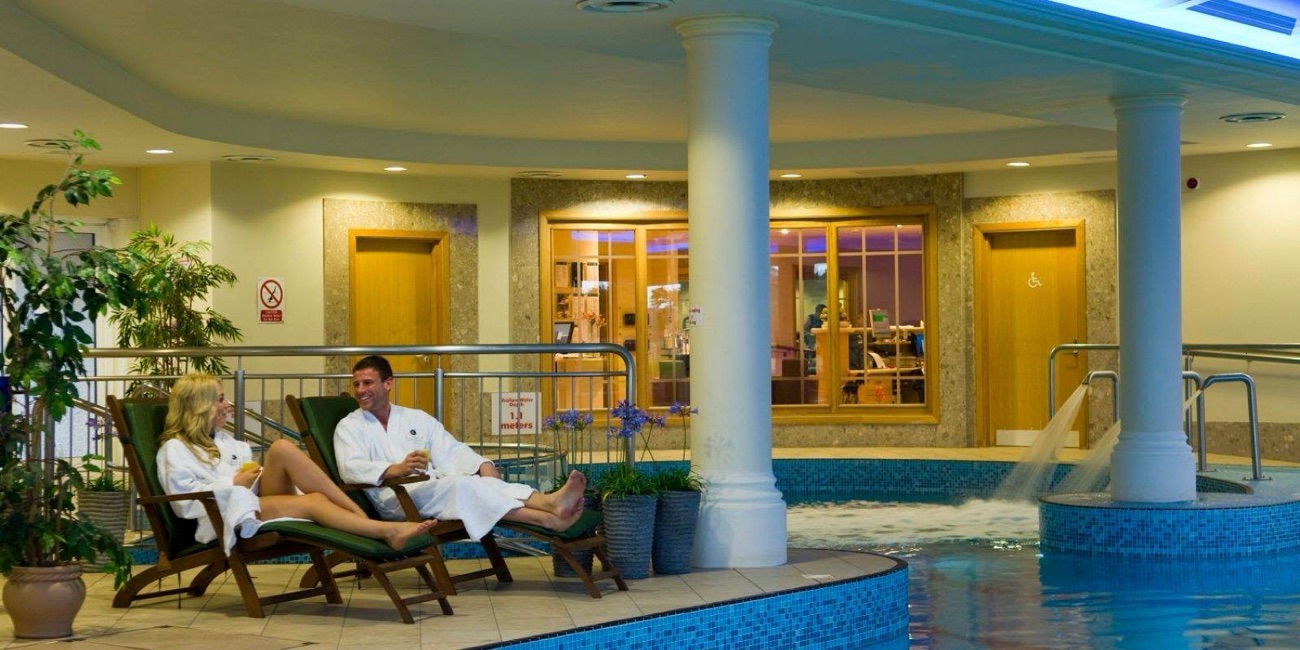 The indoor pool and hydrotherapy area, with a jacuzzi and water feature.