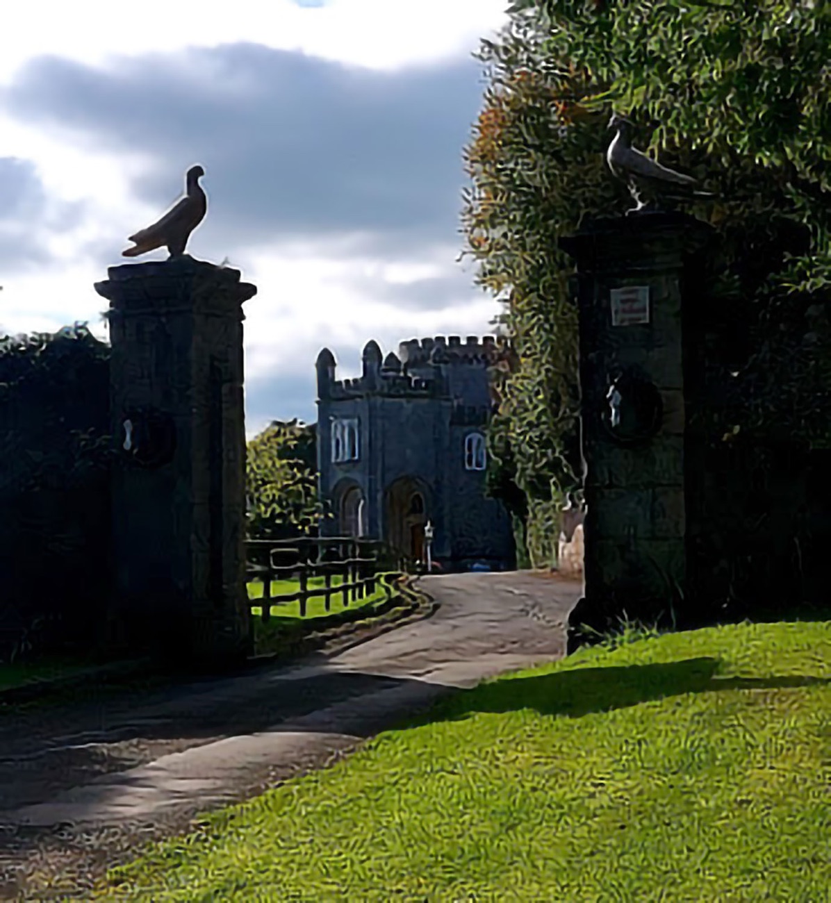 The gothic stone entrance gates to the Killymoon estate with a carved bird on the pier