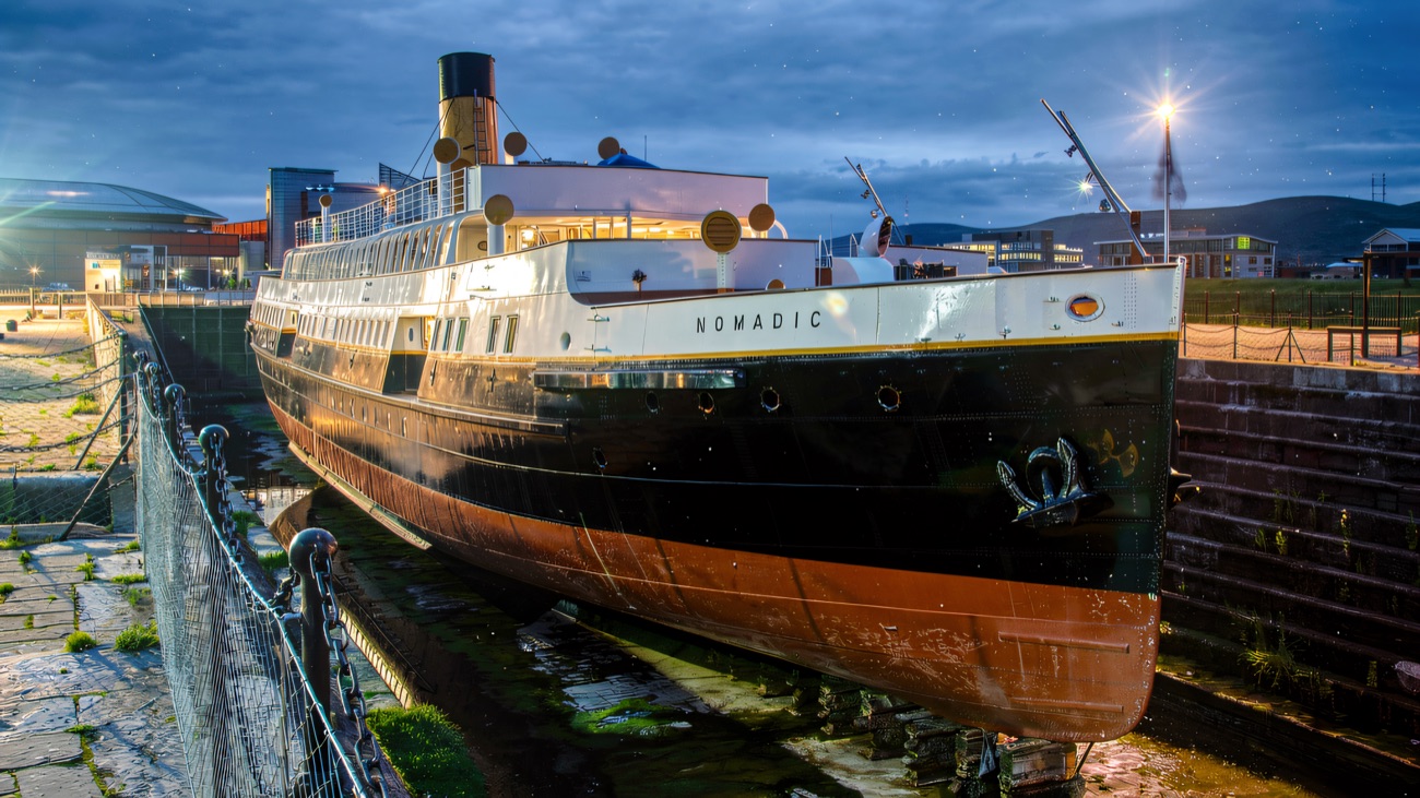 SS Nomadic lit up in her dry dock at dusk, a Titanic Quarter landmark