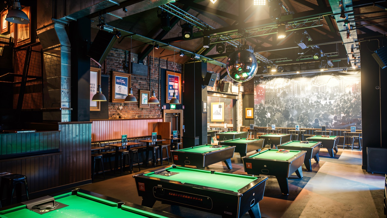 The upstairs pool room under the roof beams, with its mirrorball and stage lighting